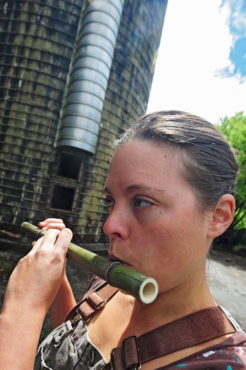 Marisha Auerbach plays a flute she made from bamboo grown at Wild Thyme Farm near Oakville Wednesday.
