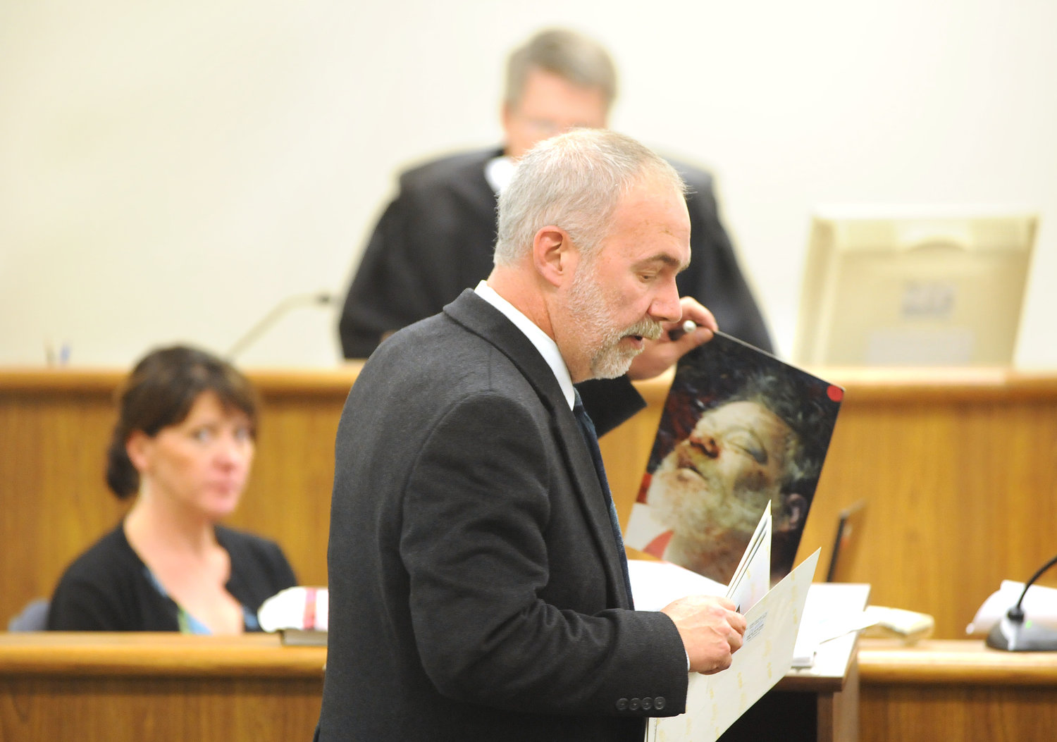 Lewis County Deputy Prosecutor Steve Scott holds up a picture of John Benson during his closing arguments in the murder trial of Kenneth Slert.