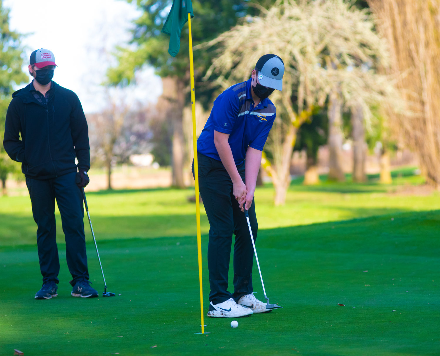 Rochester's Rowdy Edminster putts while a Tumwater players looks on at Riverside Golf Course.