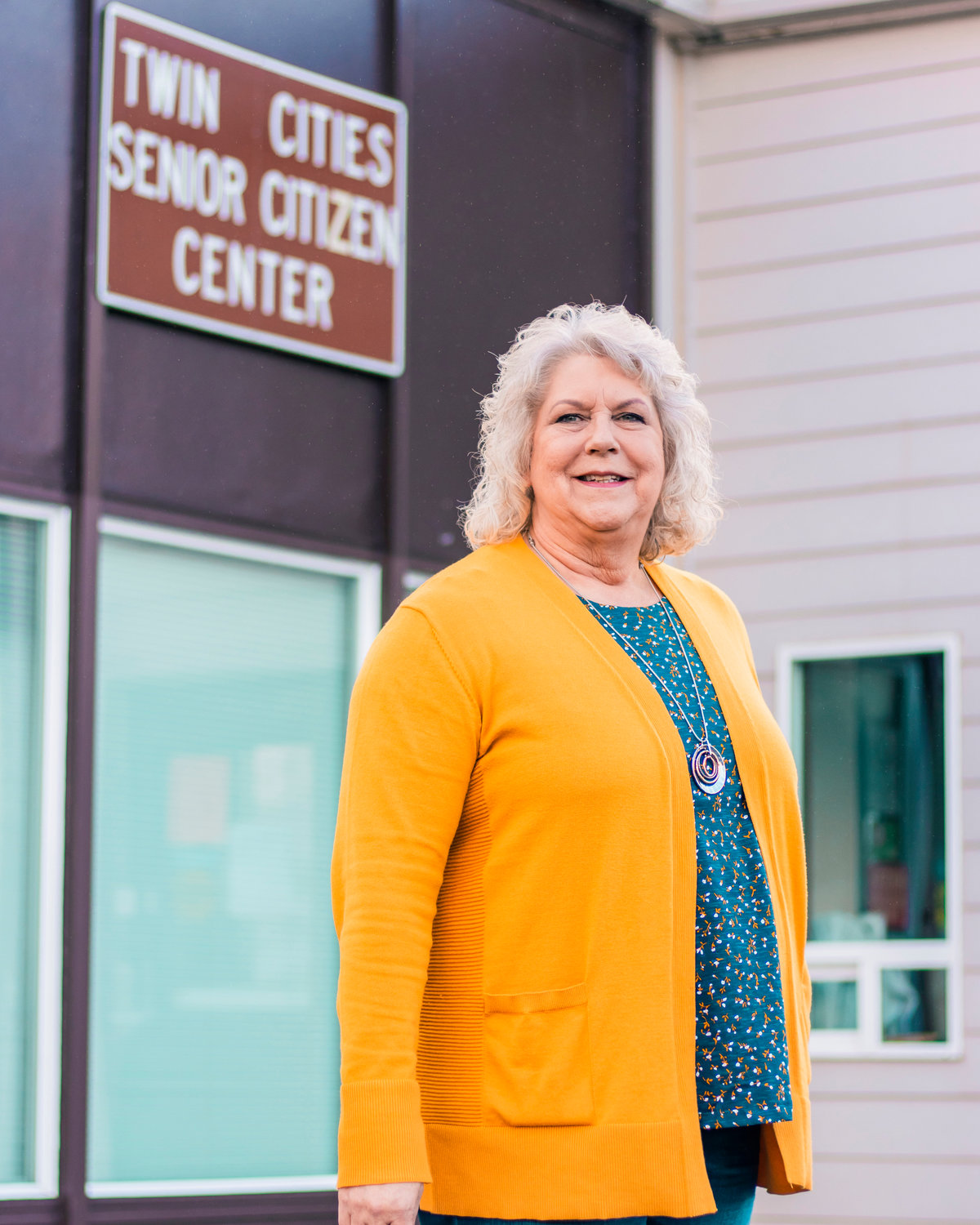 Lewis County Seniors Executive Director Glenda Forga smiles and poses for a photo outside the Twin Cities Senior Center in Chehalis on Wednesday.