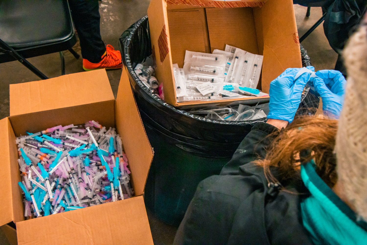 Syringes are prepped inside the Community Event Building in the Southwest Washington Fairgrounds during a vaccine distribution event last January.