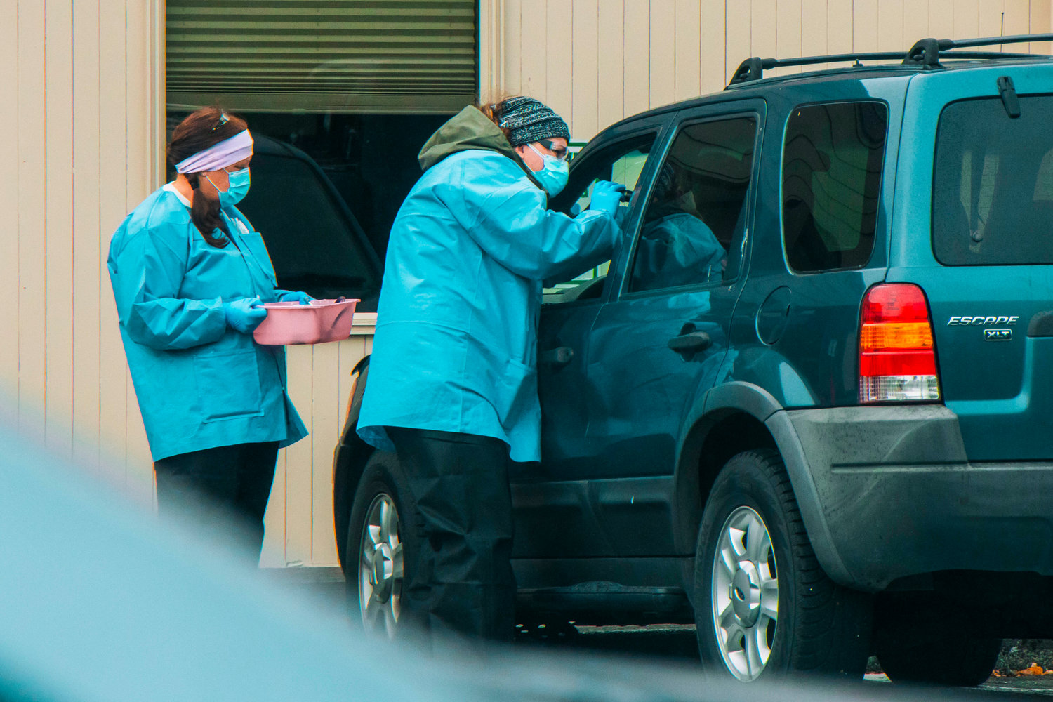 FILE PHOTO — Medical personnel at Valley View Health Center examine a patient at a drive-up COVID-19 testing site.