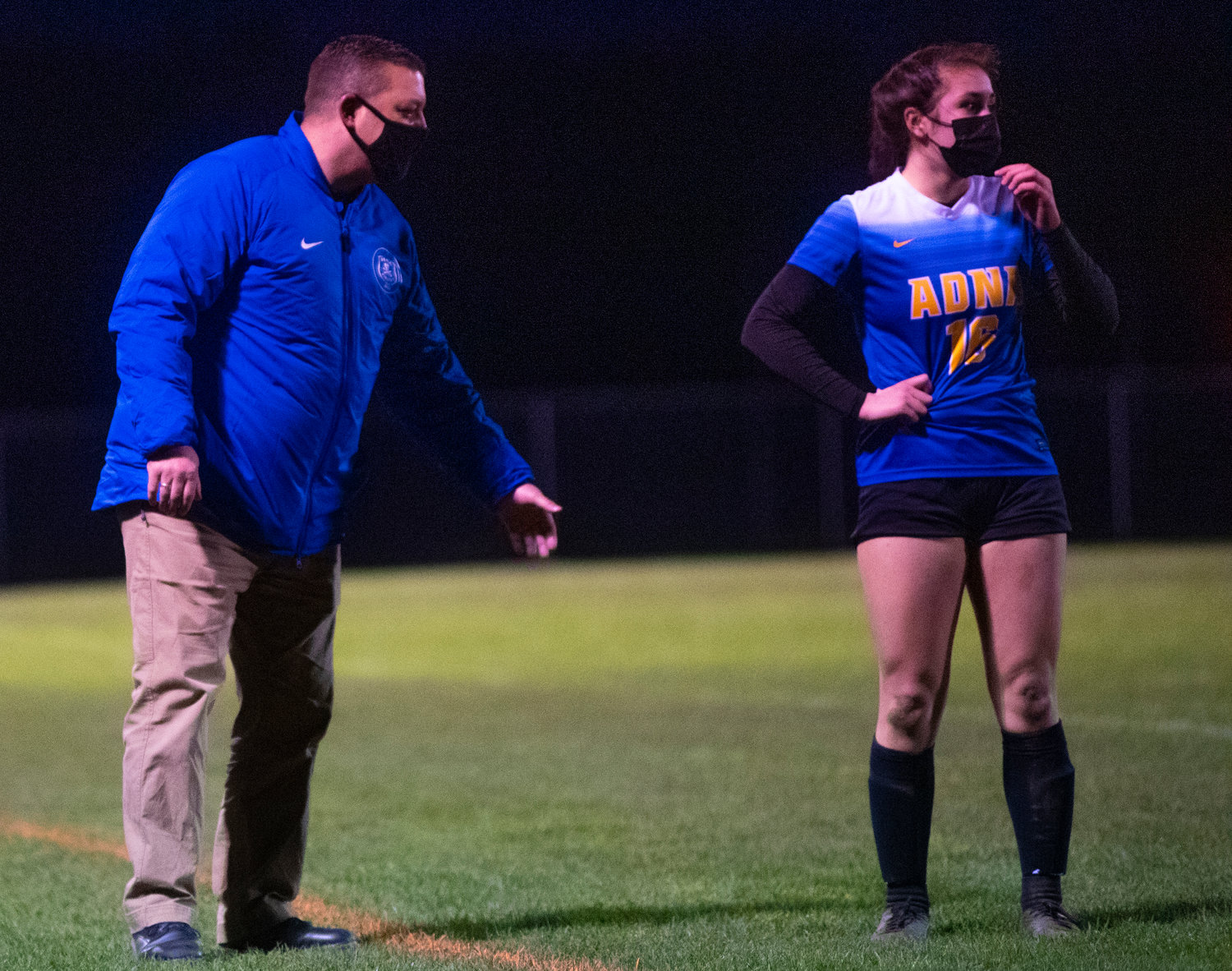 Adna coach Horst Malunat, left, gives instructions to Zarine Walker during the Pirates' match against Napavine on Wednesday.