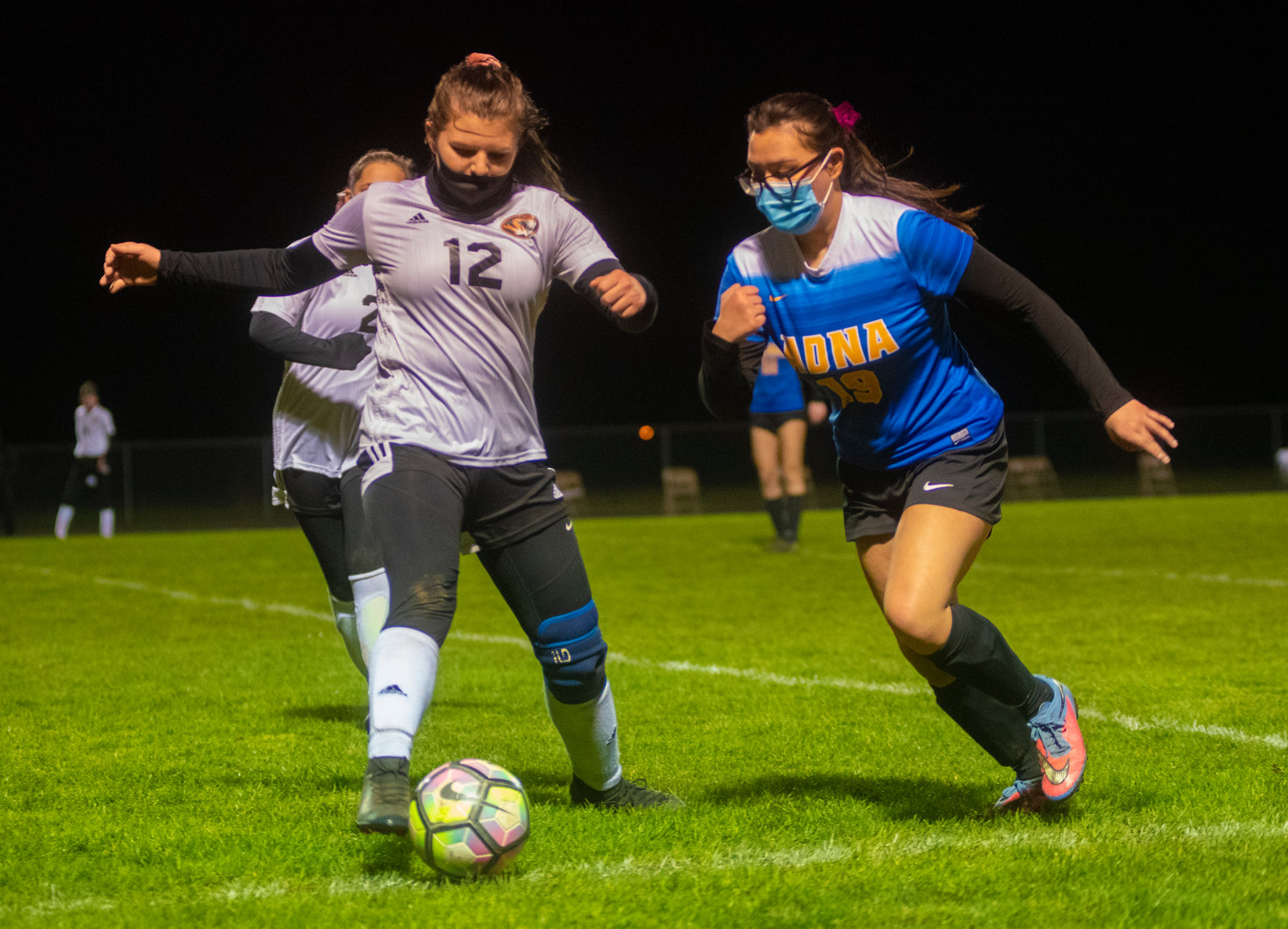 Napavine's Madison Lopes (12) tries to keep the ball away from Adna's Leanna Tripp.