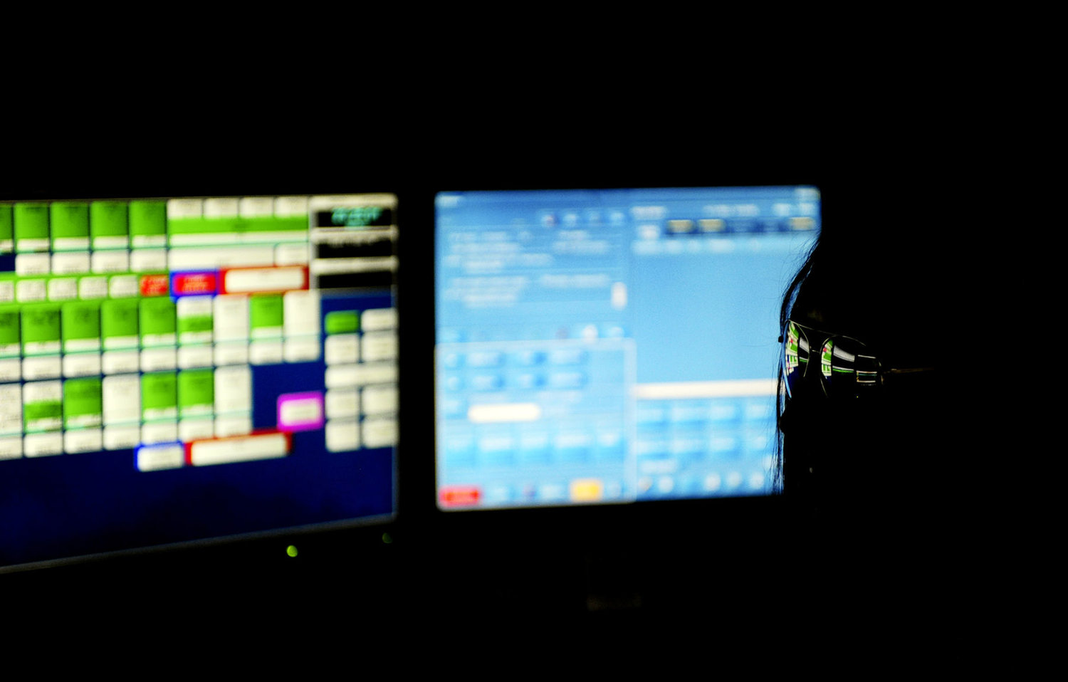 In this Sept. 11, 2012, file photo, sunglasses reflect the computer screens in front of a Lewis County 911 Communications Center dispatcher as she takes a call during a Friday night shift. The center is located on the top floor of the Lewis County Courthouse.