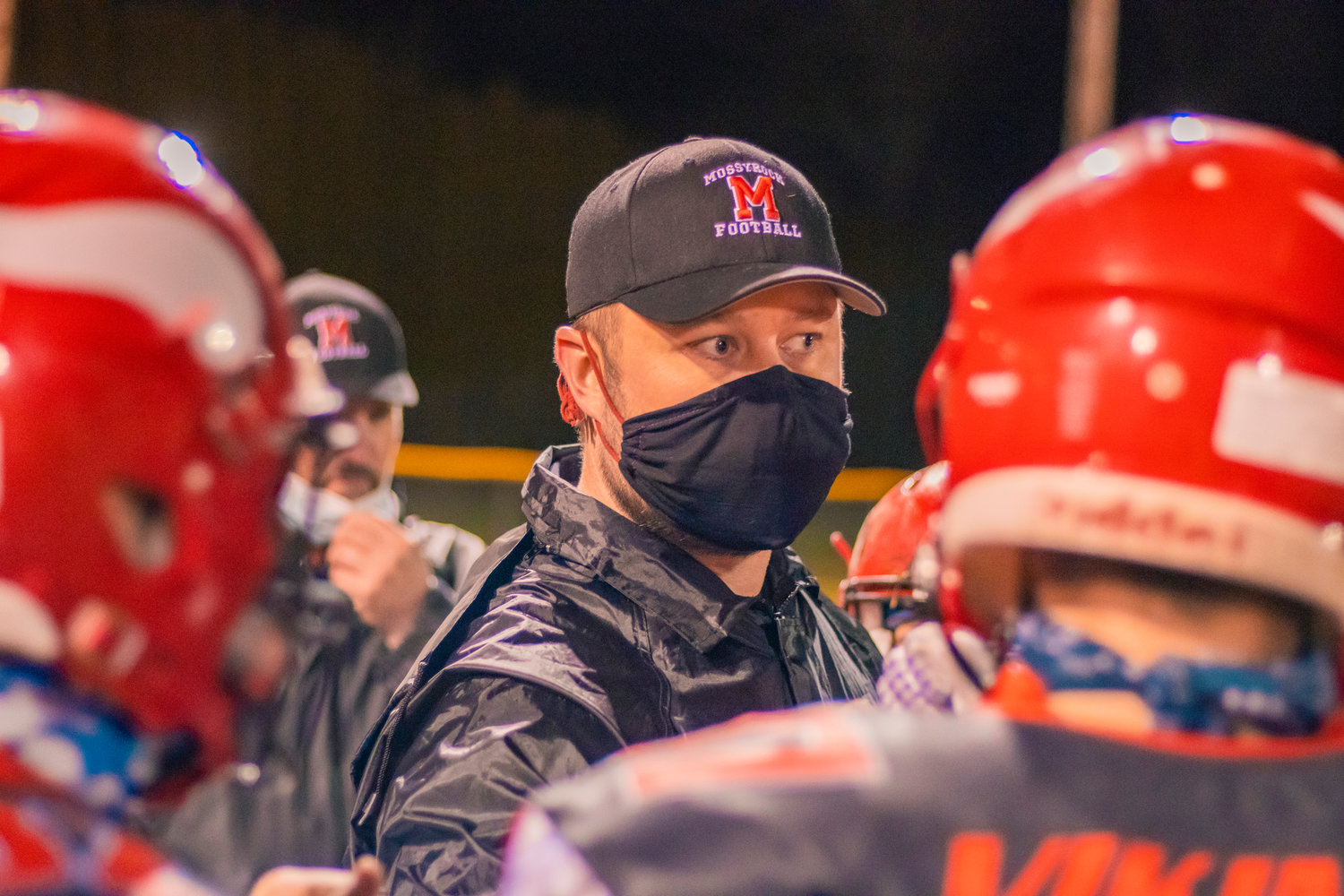 Vikings’ Head Coach Eric Ollikainen talks to players during a game against the Cardinals Friday night in Mossyrock.