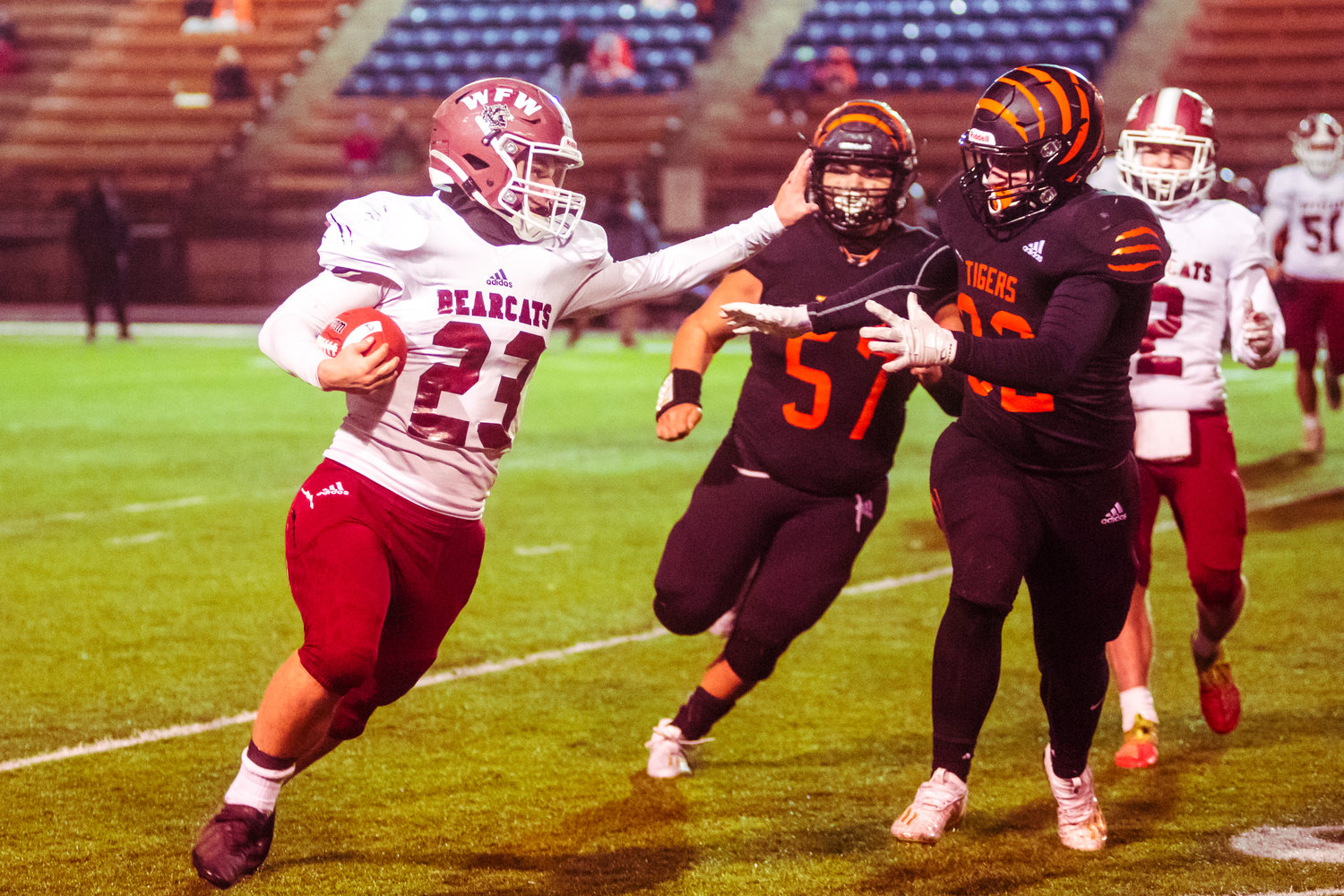 W.F. West's Luke Wichert (23) looks at a defender as he runs with the football during the Swamp Cup game against Centralia Saturday night at Tiger Stadium.