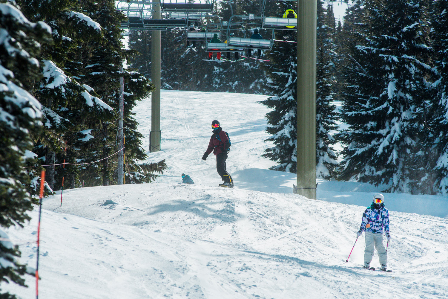 Skiers and snowboarders make their way down the mountain at White Pass Ski Area on Sunday.