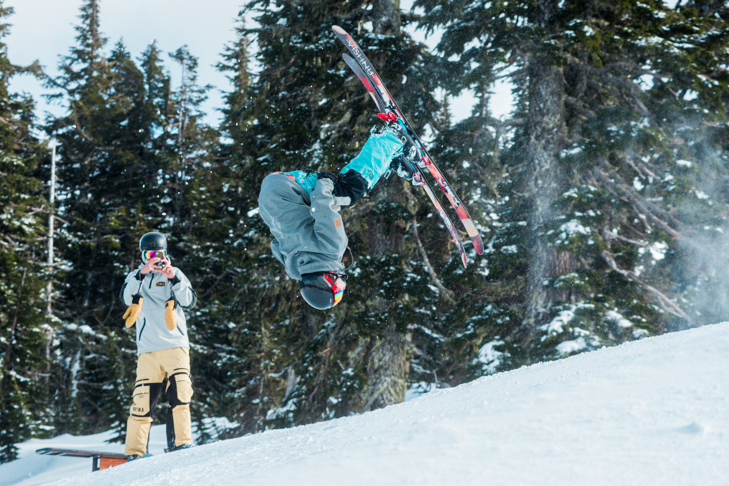 Friends film as a flip is attempted at the Ribeye jump park inside the White Pass Ski Area on Sunday.