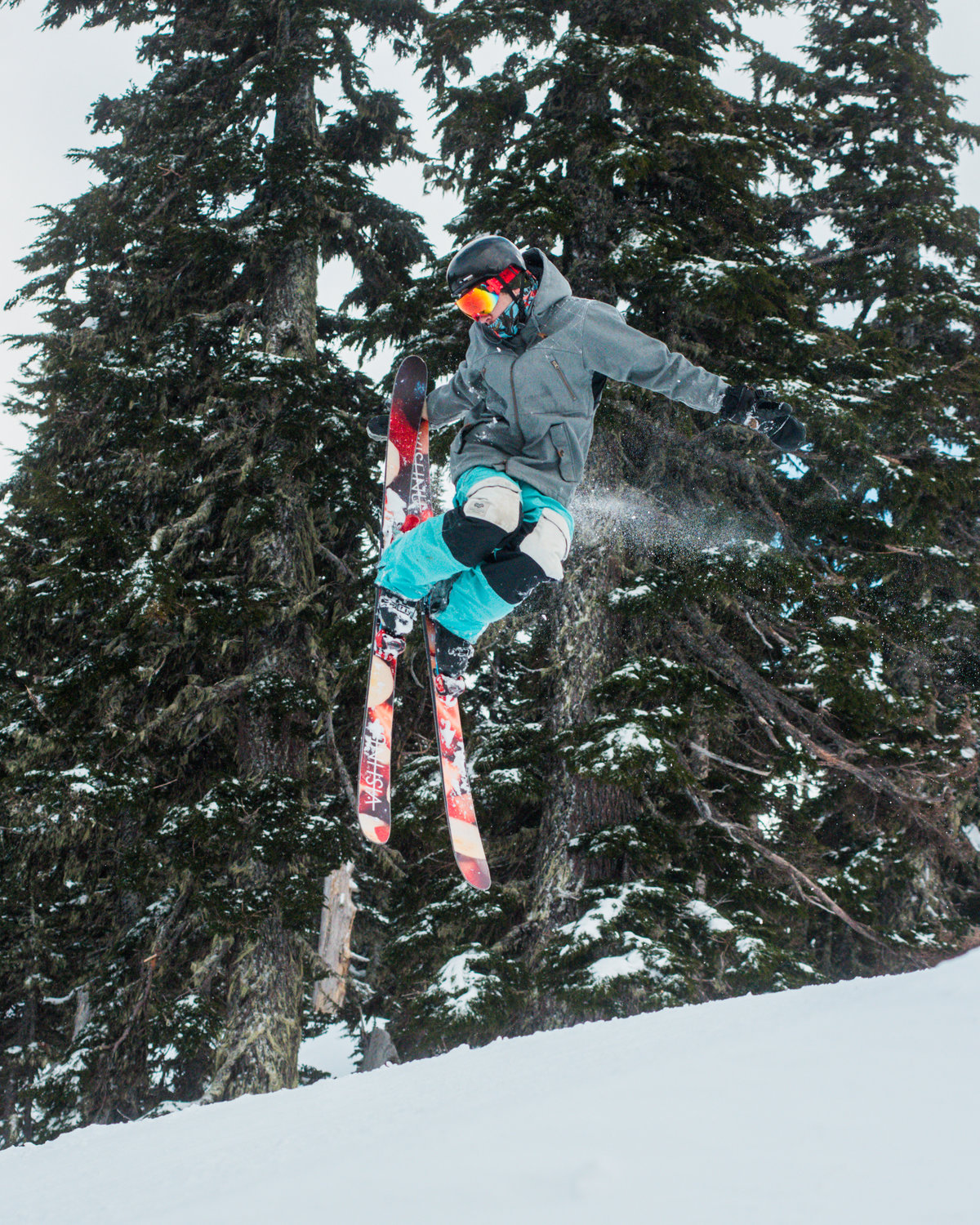 A skier makes a grab as they take air at the Ribeye jump park inside the White Pass Ski Area on Sunday.