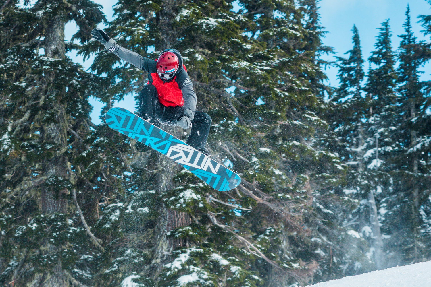 A snowboarder takes air at the Ribeye jump park inside the White Pass Ski Area on Sunday.