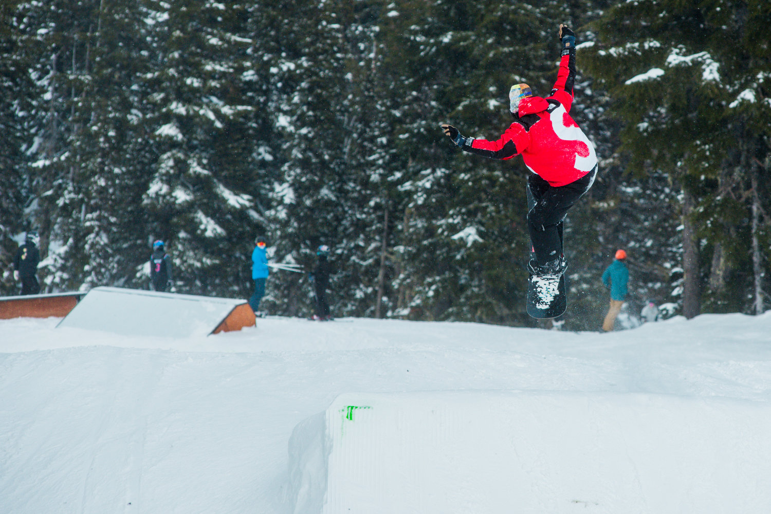 A snowboarder sits a jump at Ribeye inside the White Pass Ski Area on Sunday.