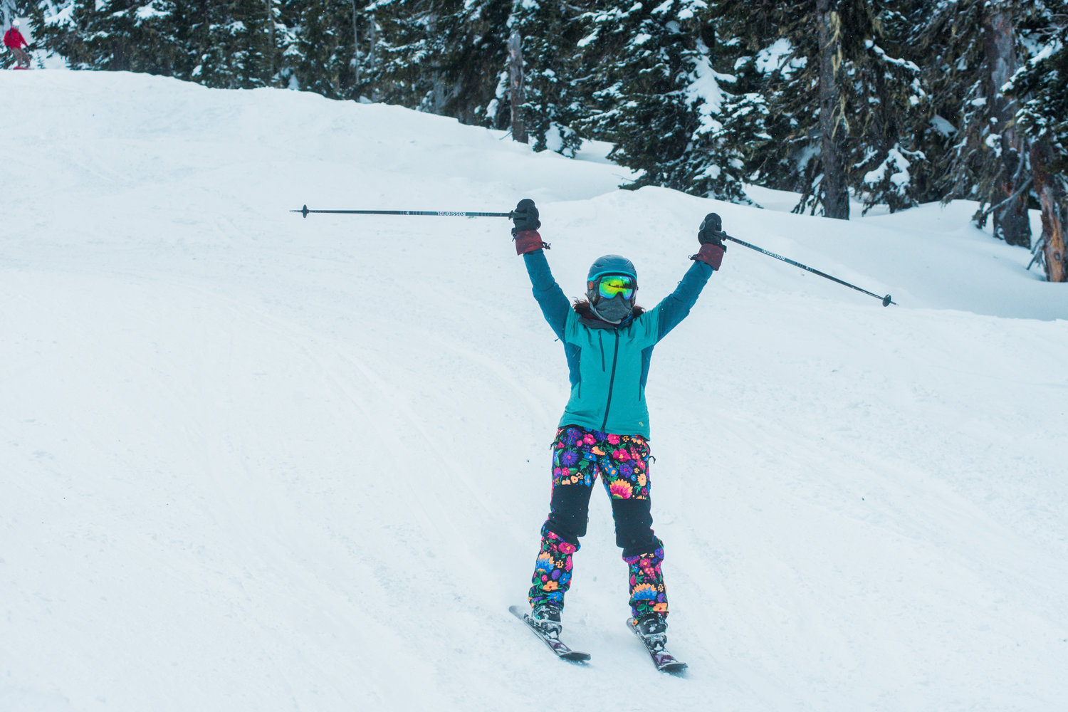 A skier holds her poles in the air while making her way down the mountain at the White Pass Ski Area on Sunday.