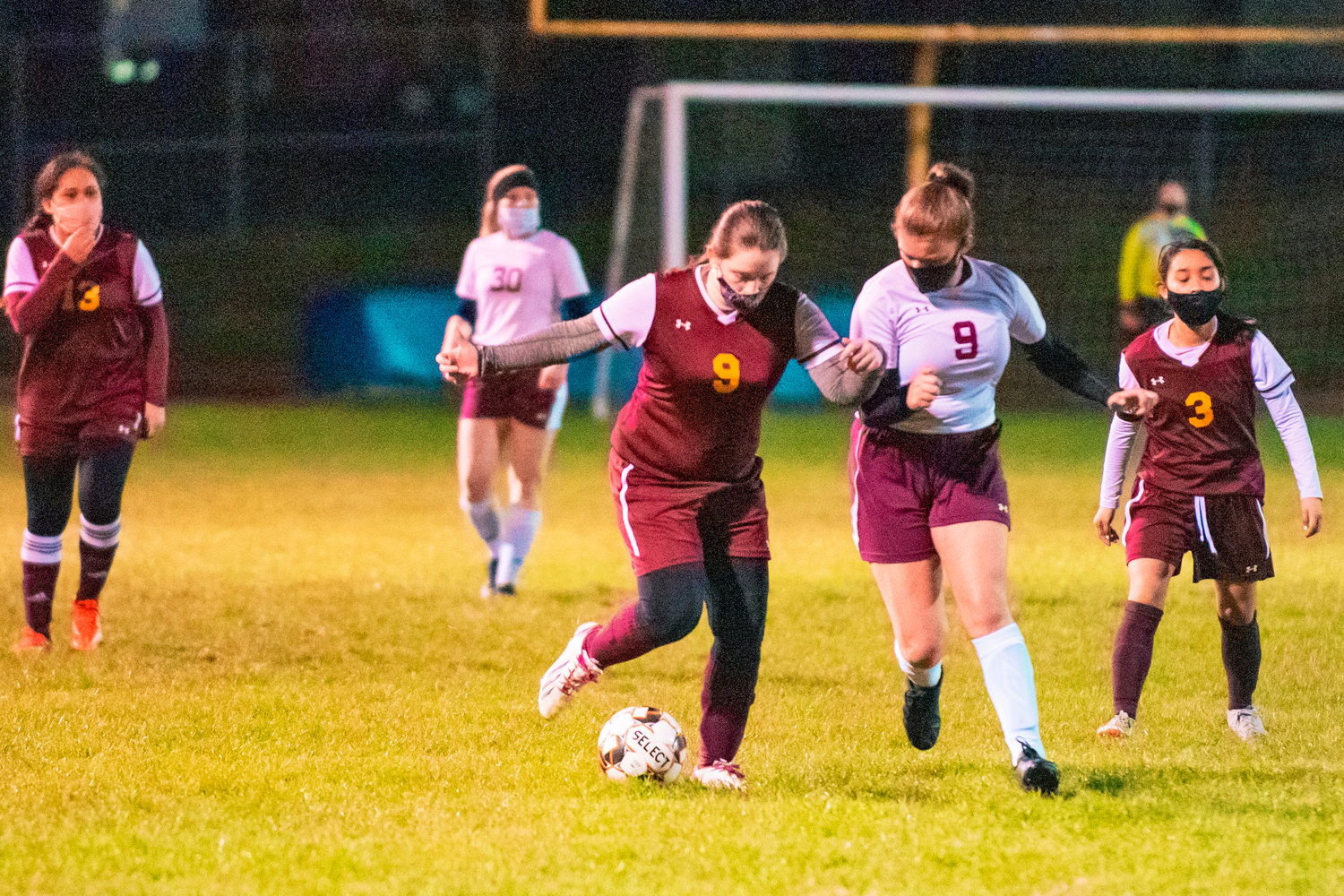 Cardinals’ Maggie Maddox (9) fights for possession of the ball during a game Wednesday night in Winlock.