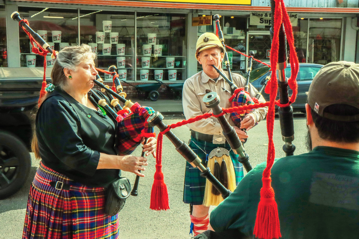 From left to right, Beverly York, Patrick Wright, and Aaron Amick play bagpipes outside of O'Blarney's Irish Pub on St. Patrick's Day in downtown Centralia.