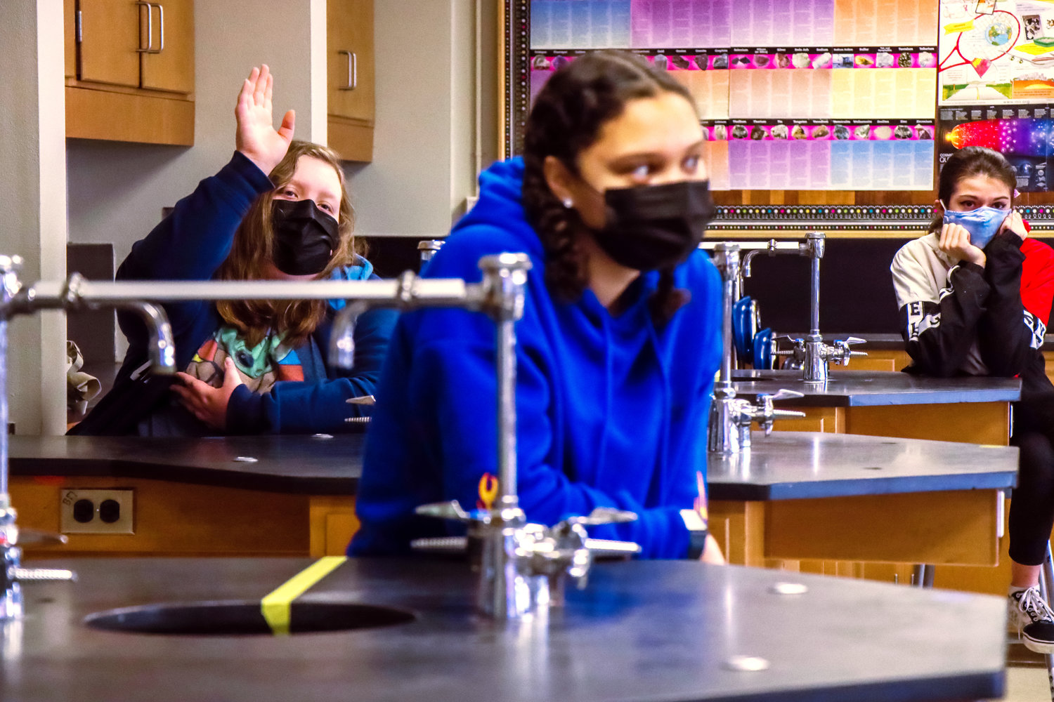 A student raises her hand during science class at Centralia Middle School Friday morning.