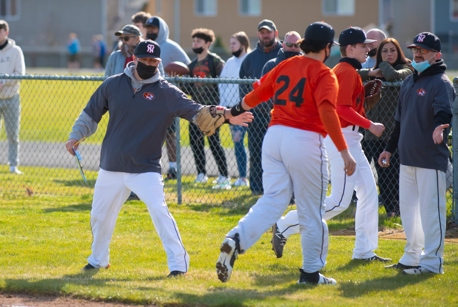 Napavine coach Brian Demarest, left, high-fives sophomore Deacon Parker (24) after the Tigers' recorded three outs in the second innning against Toutle Lake on Tuesday.