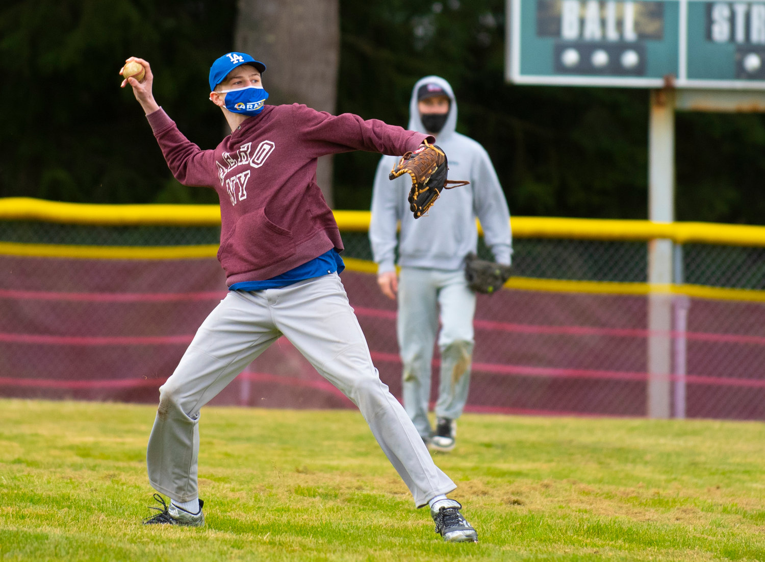 Winlock's Tallen Lofgren launches a throw from left field during the Cardinals' practice on March 19.