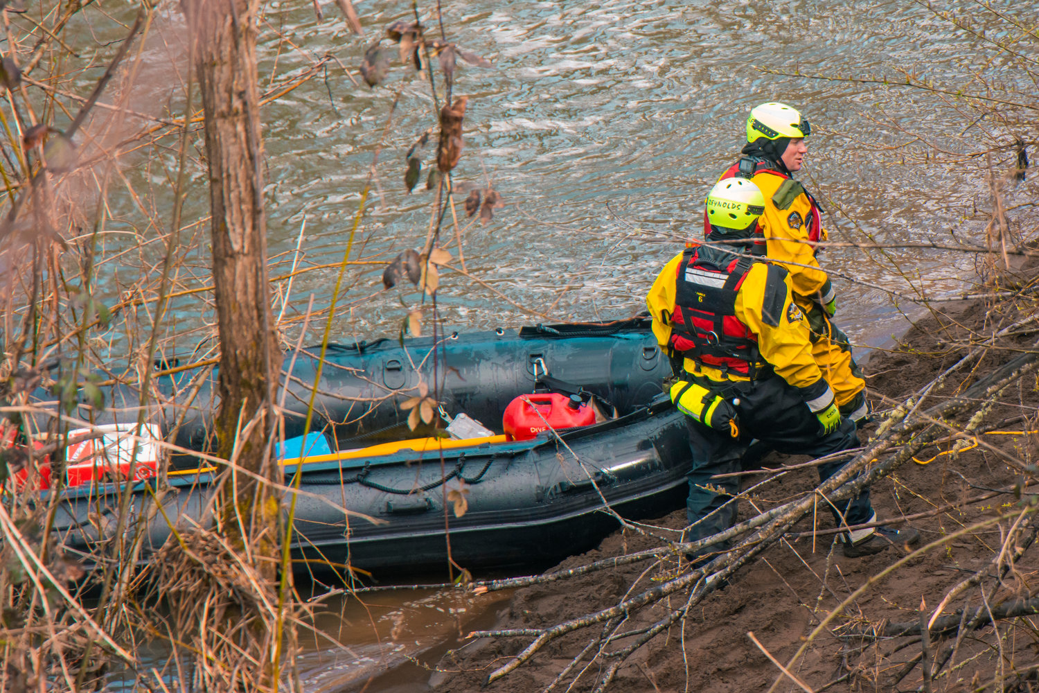 Members of the Thurston County Sheriff Dive and Rescue crew stand on the bank of the Chehalis River during a search for missing teen Zach Hines-Rager in Adna.