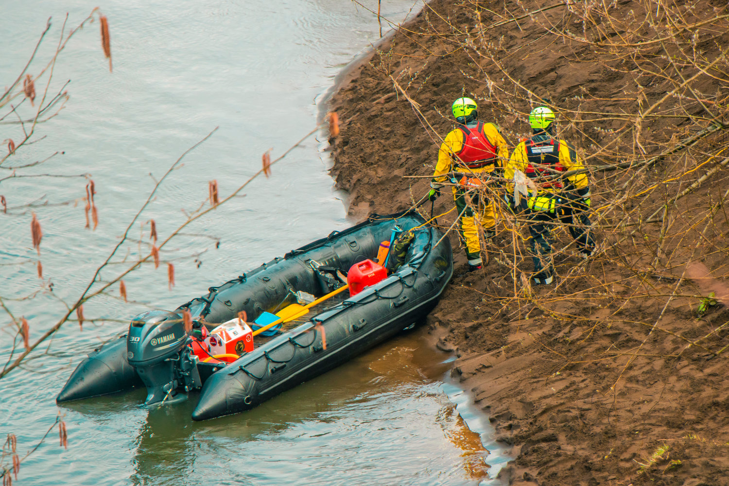 Members of the Thurston County Sheriff Dive and Rescue crew stand on the bank of the Chehalis River during a search in Adna.