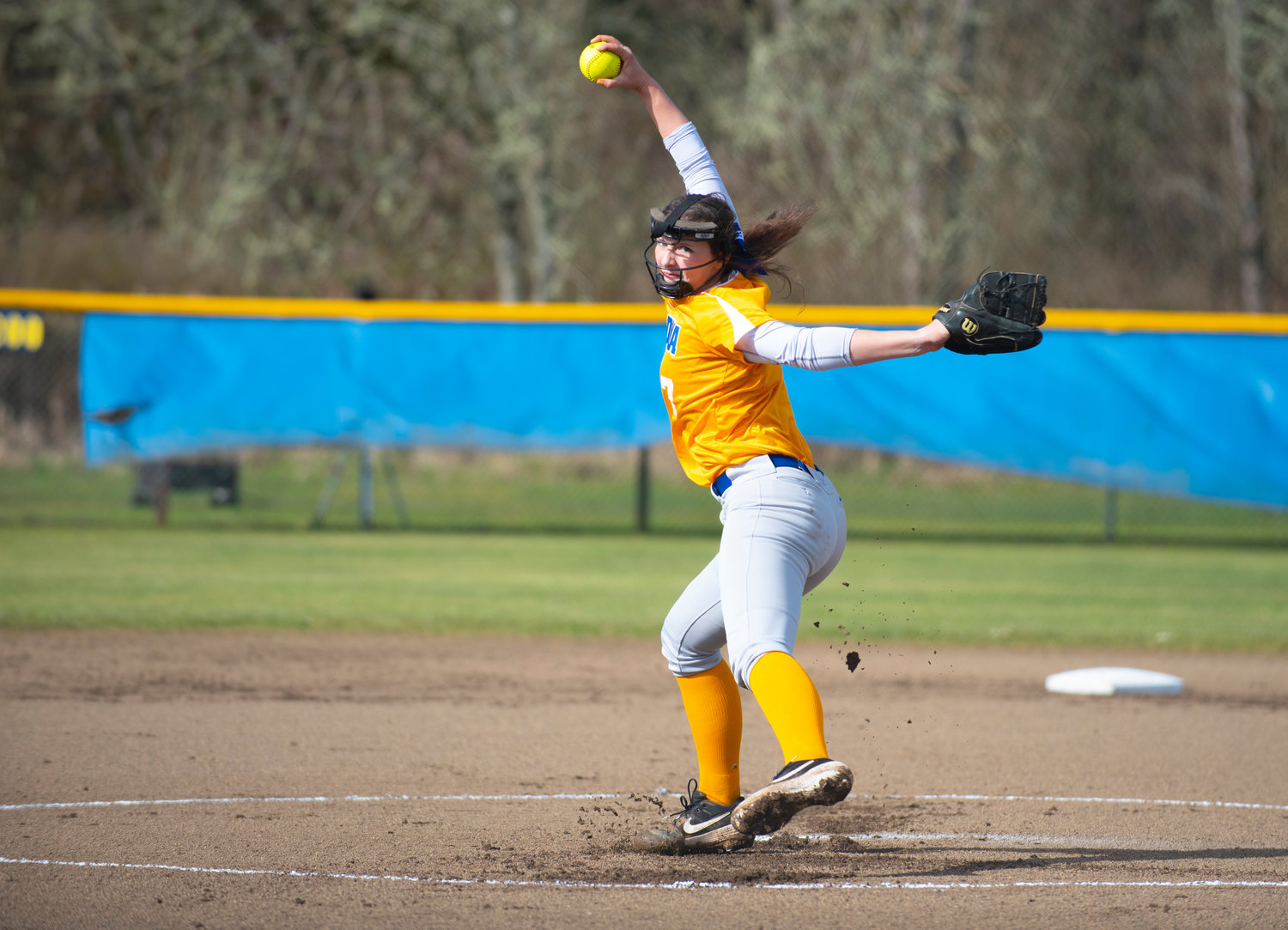 Adna pitcher Haley Rainey winds up for a first-inning pitch against Winlock Friday at home.