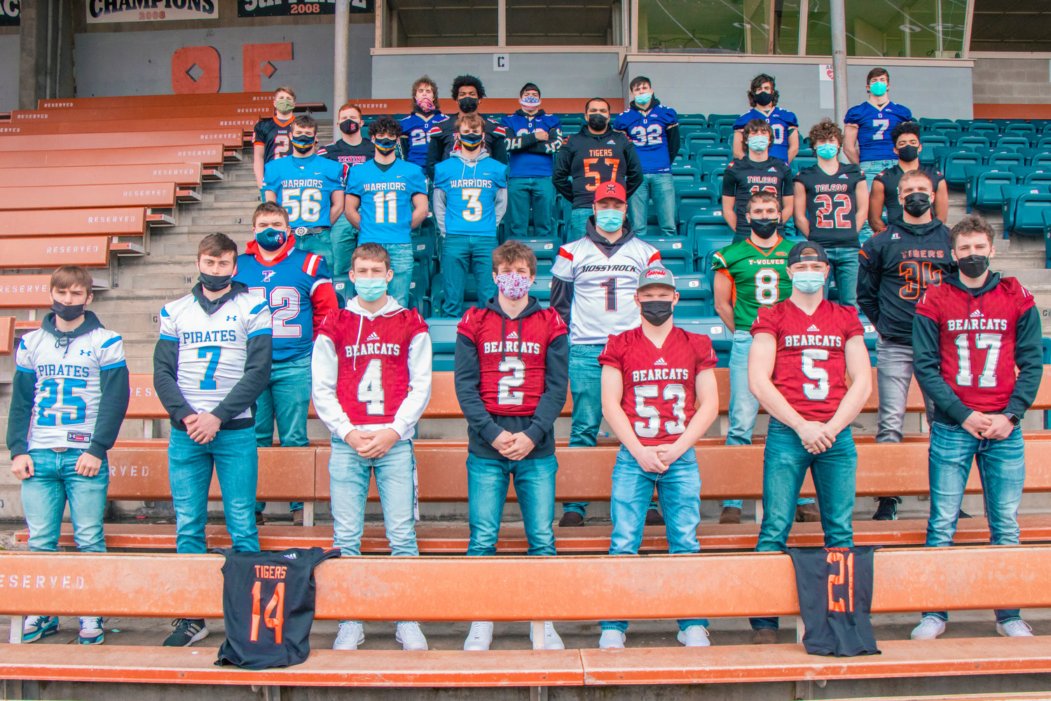 Athletes chosen for the All-Area Football team pose for a photo at Tiger Stadium sporting their school’s football jerseys.