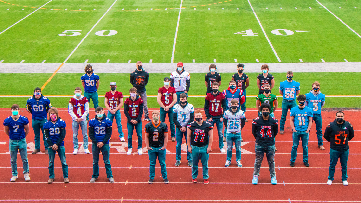Athletes chosen for the All-Area Football team pose for a photo at Tiger Stadium sporting their school’s football jerseys.