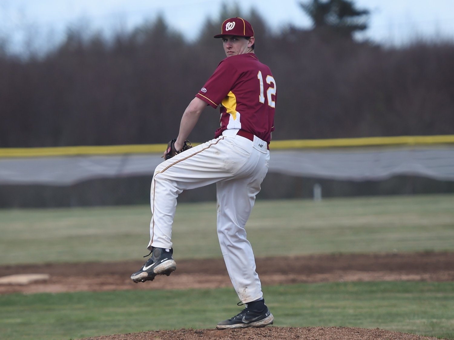 Winlock's Aiden Freitas winds up to deliver a pitch to an Ilwaco batter on Saturday, April 10, 2021.