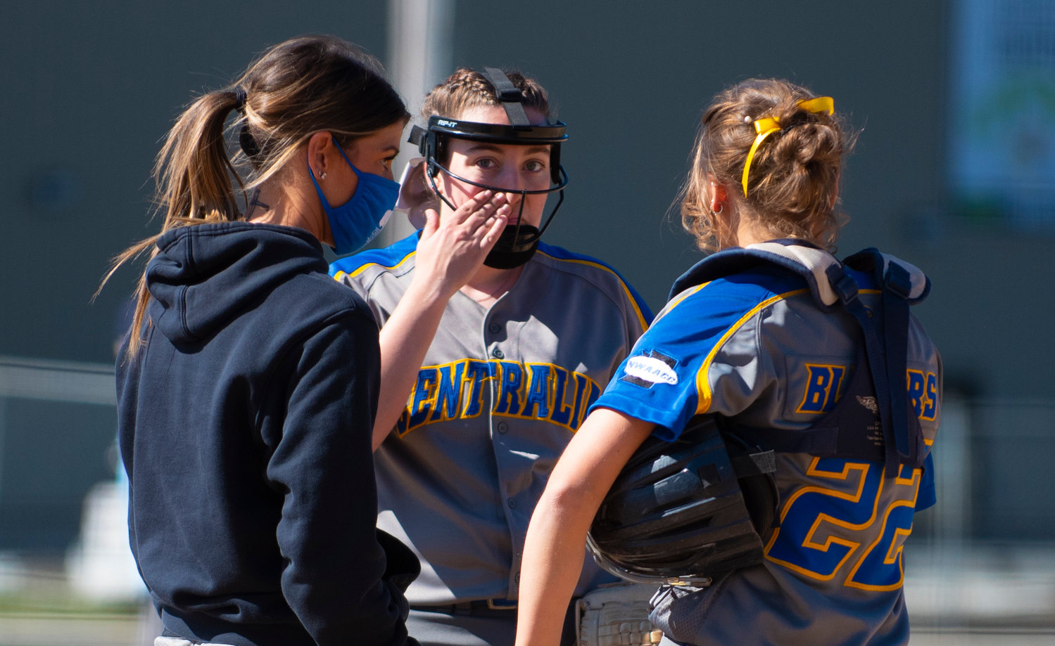 Centralia College pitcher Hailey Sneddon, middle, goes over a mid-inning gameplan with coach Katie Aden, left, and catcher Grace Hodel, right.