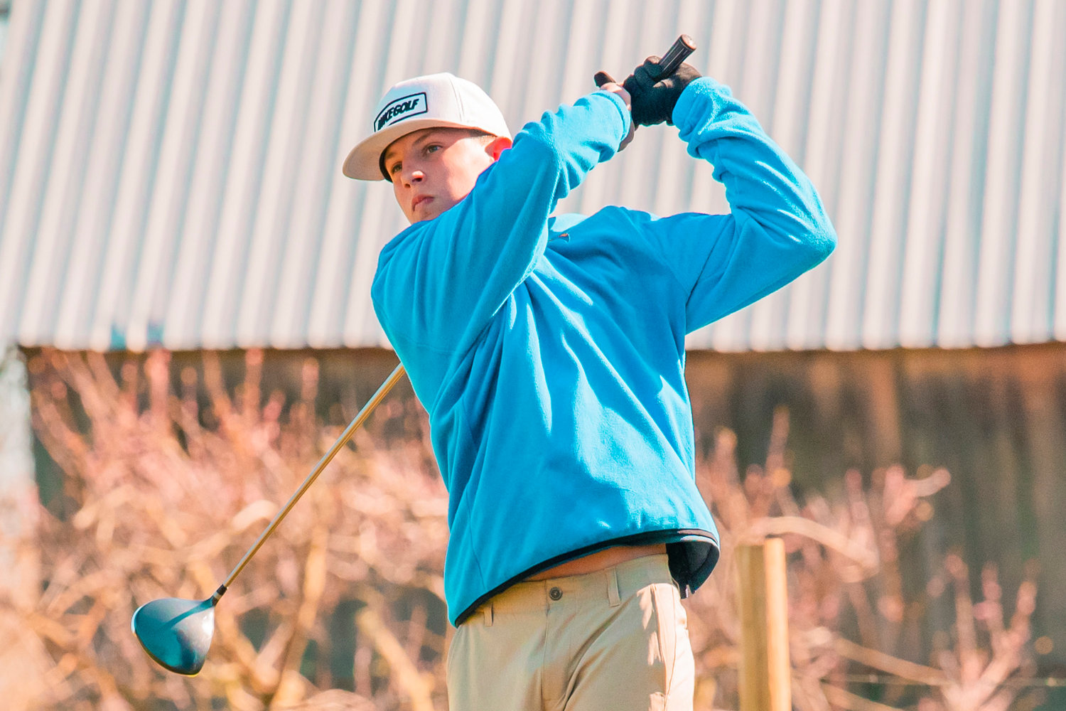 Adna’s Braeden Salme tees off and watches his shot at Riverside Golf Course in Chehalis on Monday.