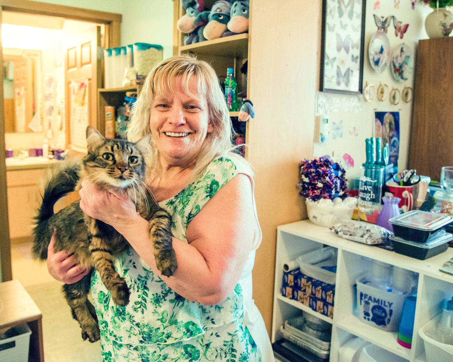 Debbie Nix smiles as she introduces her cat KJ while holding him in her Centralia residence.