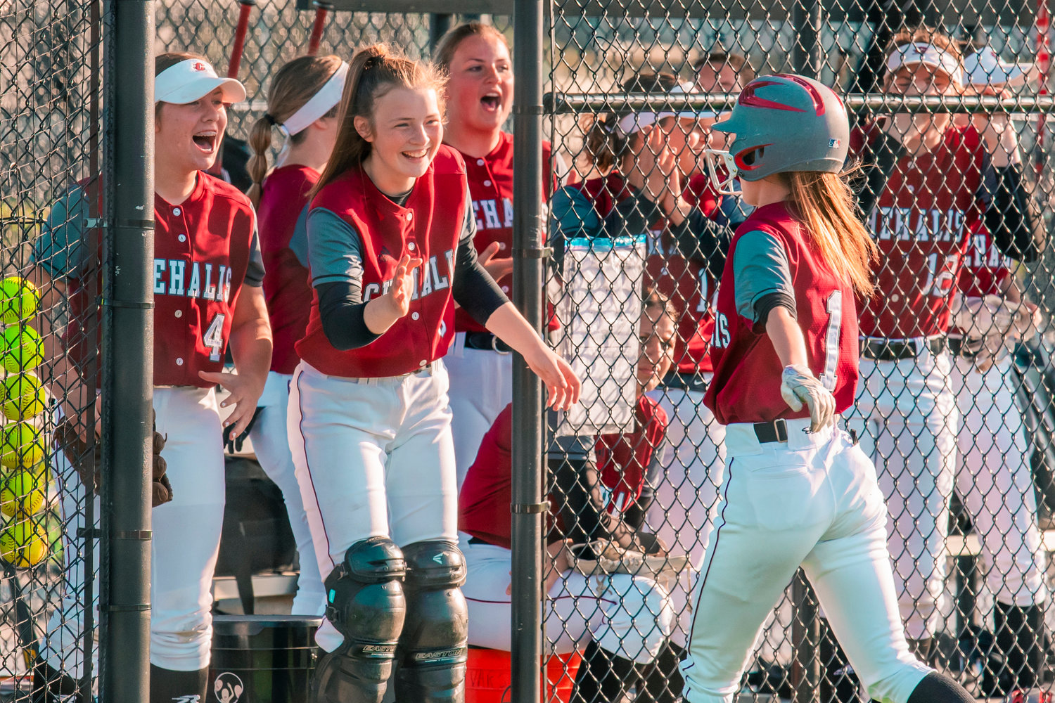 Bearcats celebrate a score as Brielle Etter (1) returns to the dugout during a game against Shelton, Tuesday afternoon in Chehalis.