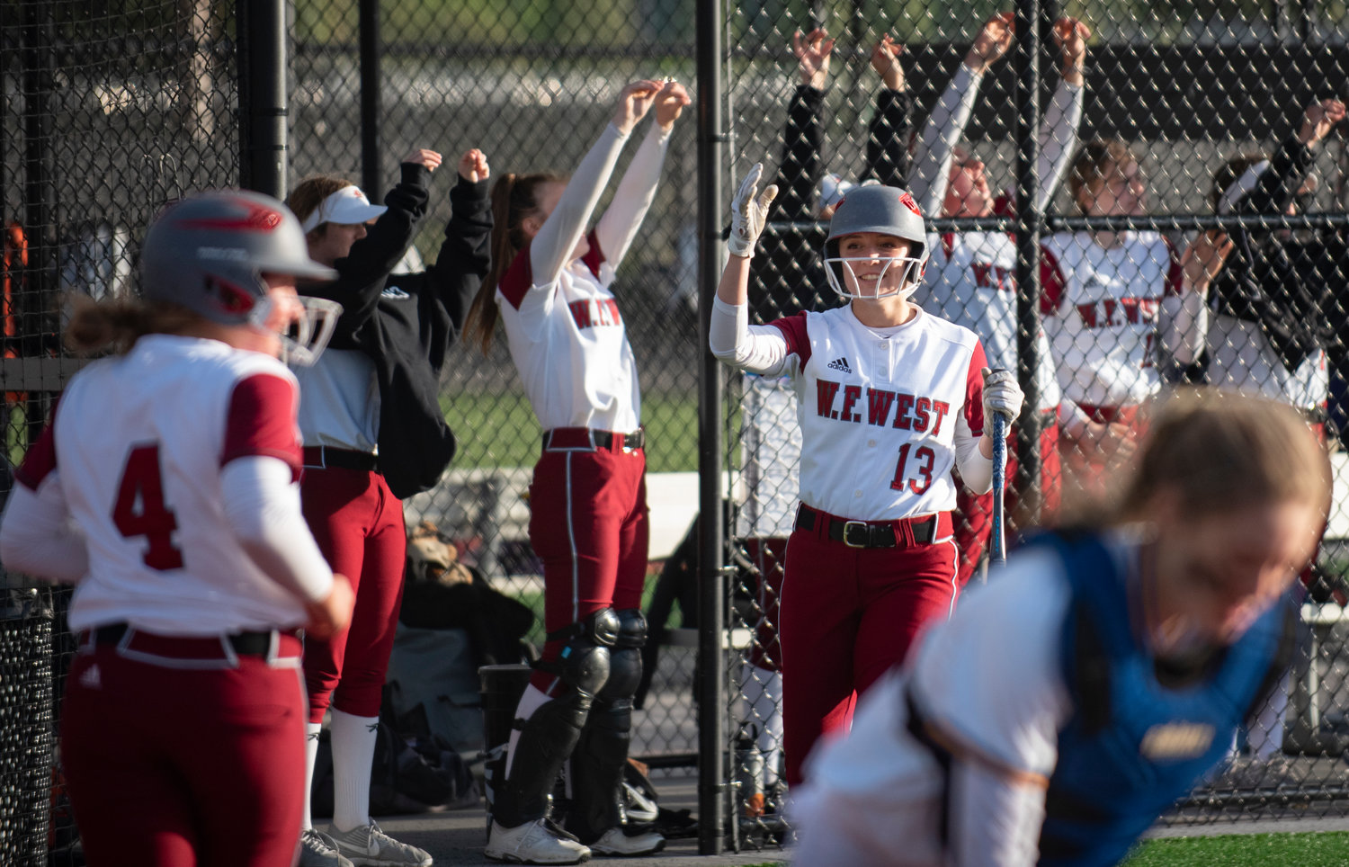 W.F. West senior Alisha Anderson (13) and the rest of the Bearcats celebrate after Lena Fragner (4) scores the first run of the game against Rochester on Thursday.
