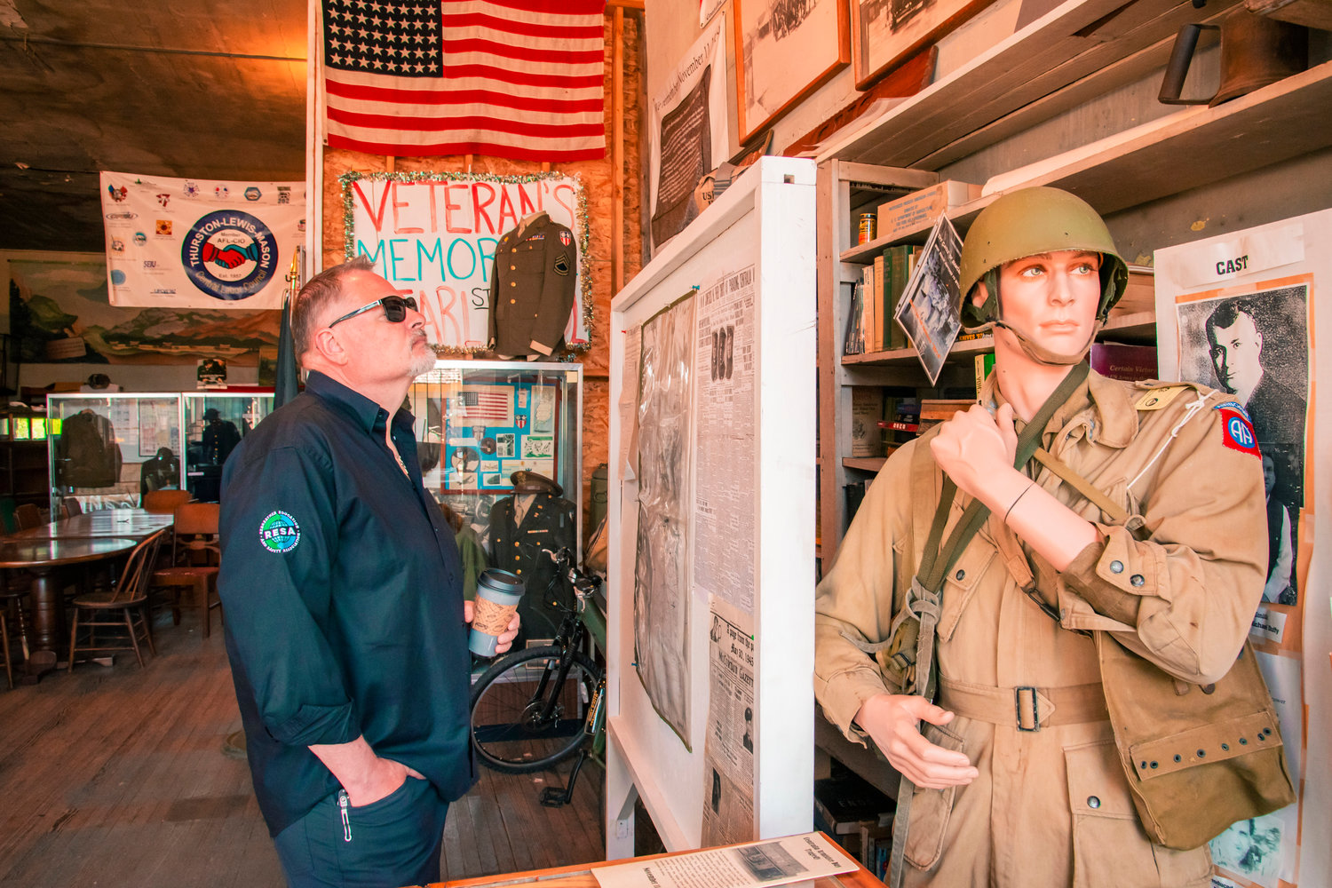 Visitors read info boards inside the America’s Team Military Museum on Saturday in downtown Centralia during Armed Forces Day.