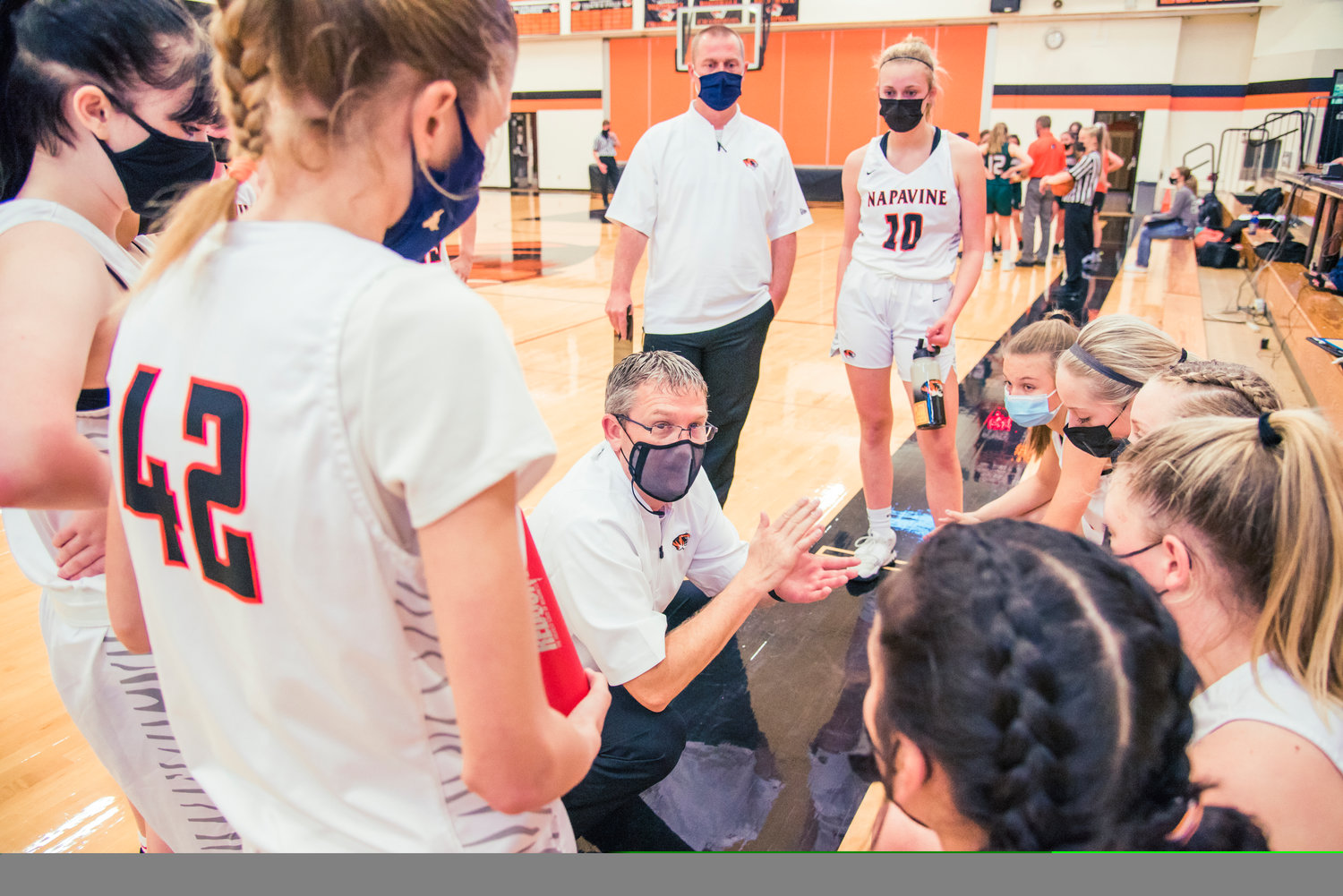 Napavine coach Shane Schutz goes over a gameplan with the Tigers during a timeout on Tuesday.