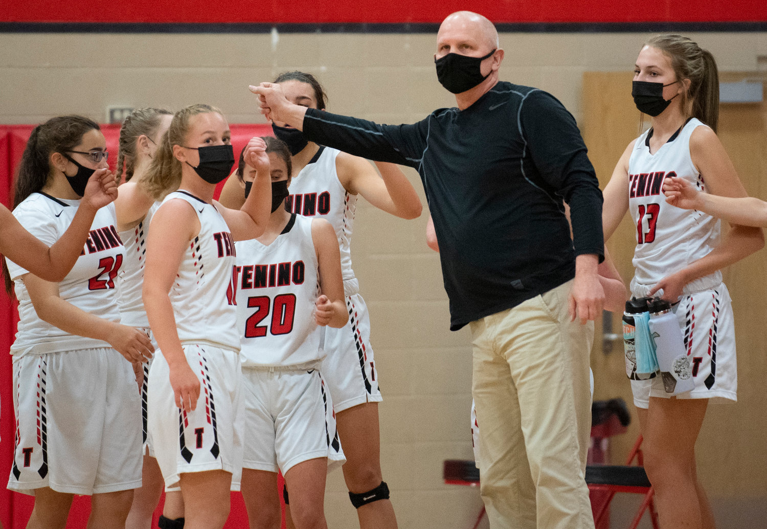 Tenino coach Scott Ashmore and the Beavers break from a timeout during a game against Elma on Saturday.