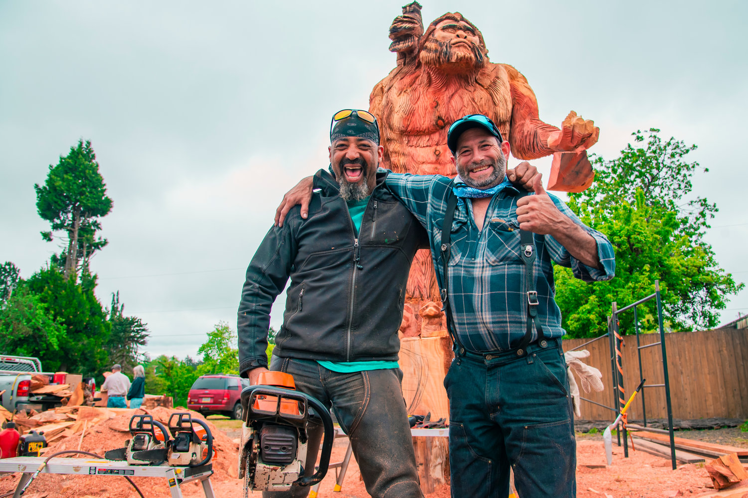 Tony Robinson and Bernie Madison pose for a photo in front of their 17-foot Sasquatch carved with chainsaws into a sequoia 7-feet in diamete in downtown Oakville.
