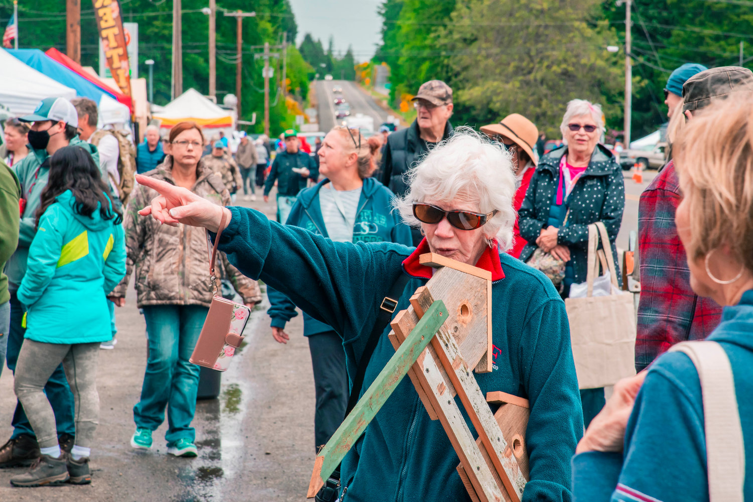Dixie Jasinto points to food vendors after making a purchase at the Packwood Flea Market on Friday.