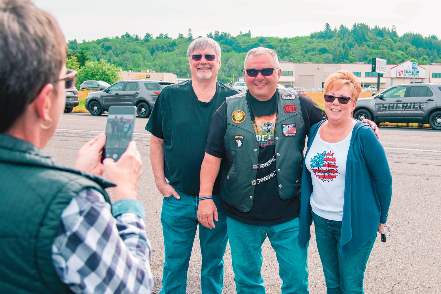 Loren Culp, who is part of the motorcycle procession during the Beyond the Call of Duty Ride to Remember 2020 memorial ride, poses for photos at the Chehalis Washington State Patrol office on Sunday.