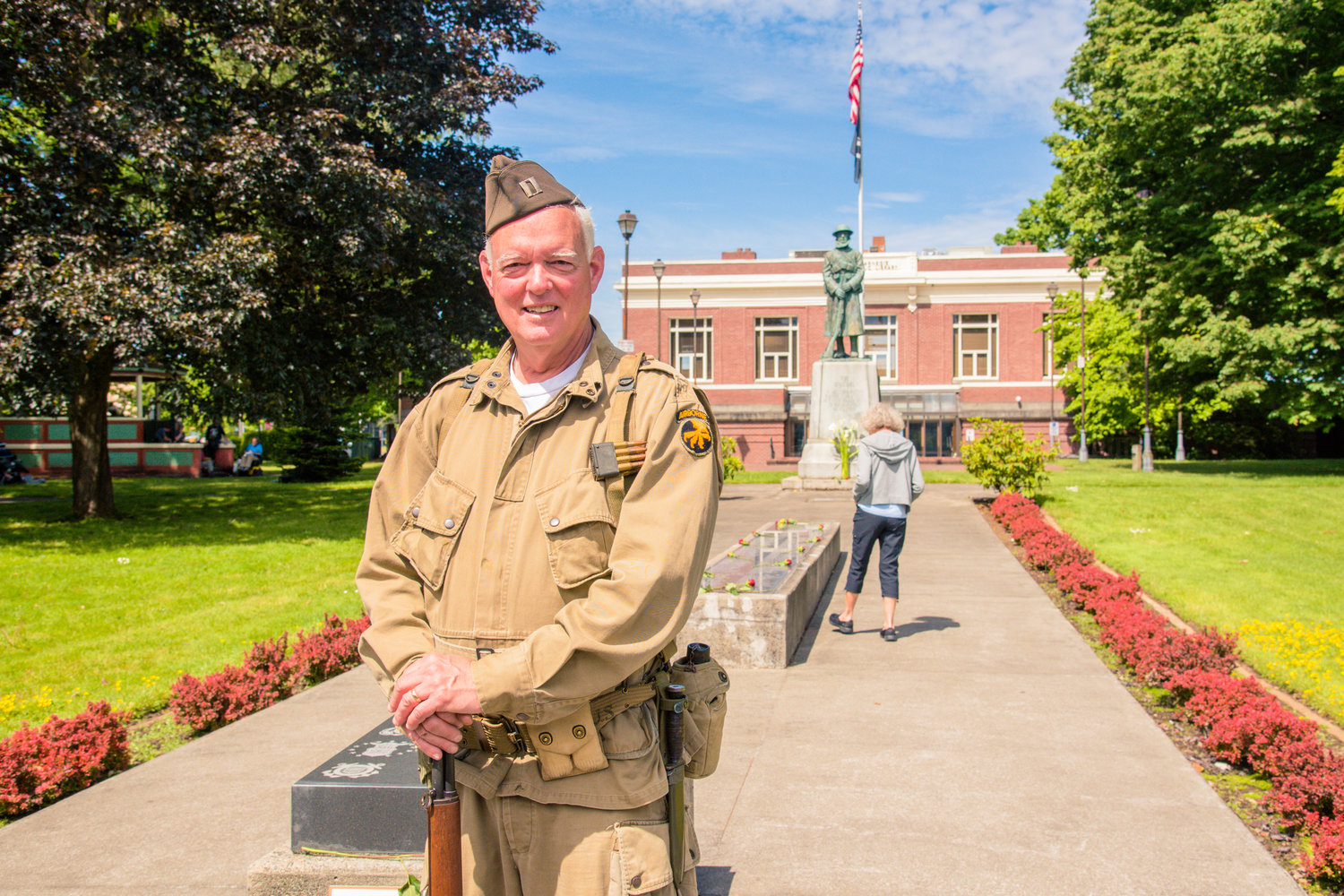 America’s Team Museum owner Peter Lahmann sports a World War II era jumpsuit on Memorial Day while providing information and history to visitors at George Washington Park in Centralia Monday morning.