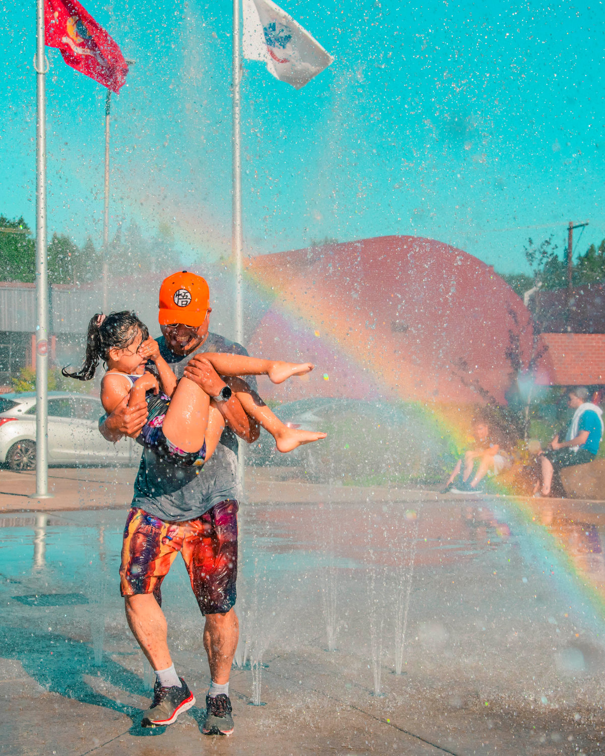 Lino Andablo carries his daughter Luna through water streams at the Centralia splash park while attempting to cool off Tuesday.