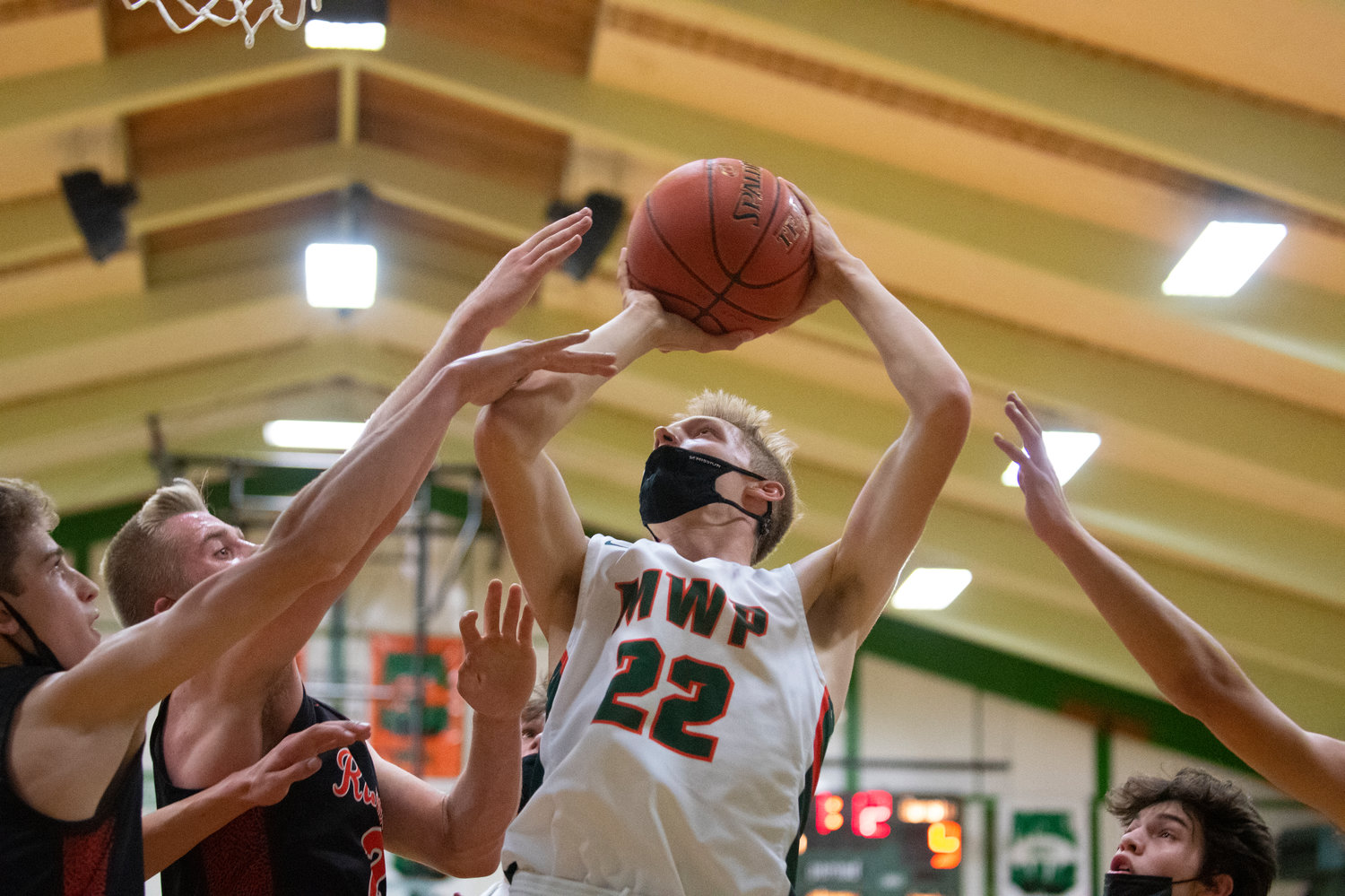 MWP junior Gary Dotson (22) goes up for two points against three Rainier defenders in Morton on Wednesday.