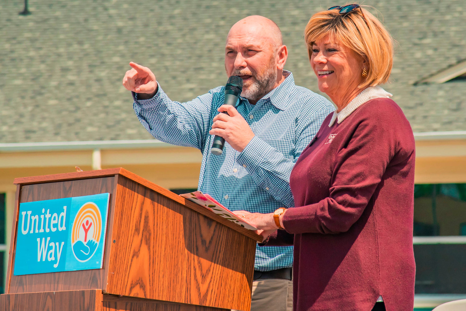 Project Manager Todd Chaput and Executive Director Debbie Campbell talk to attendees of a groundbreaking ceremony for the United Learning Center in Centralia on Tuesday.