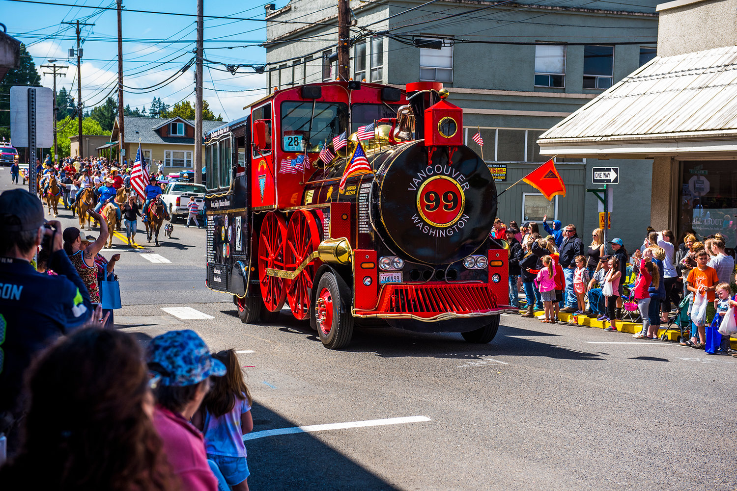 Families wave as the Egg Day parade rolls through downtown Winlock in 2019. The festival was canceled in 2020.