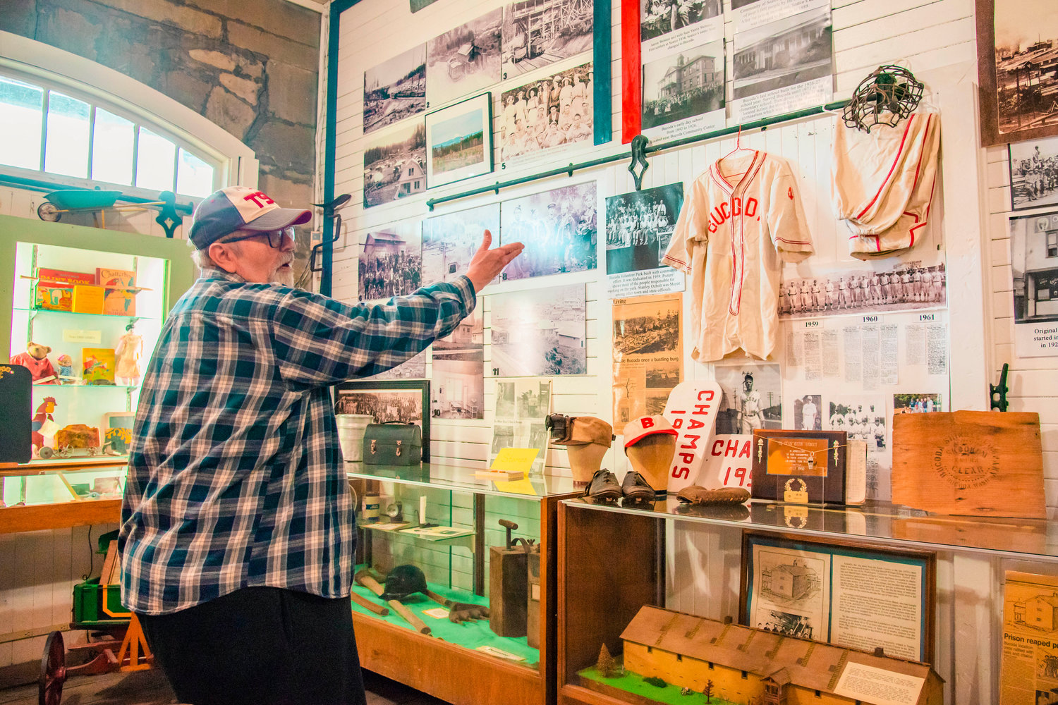 The Tenino Depot Museum is also home to historic items from other nearby towns. Tenino City Historian Richard Edwards points to Bucoda baseball equipment on display in one room of the museum.