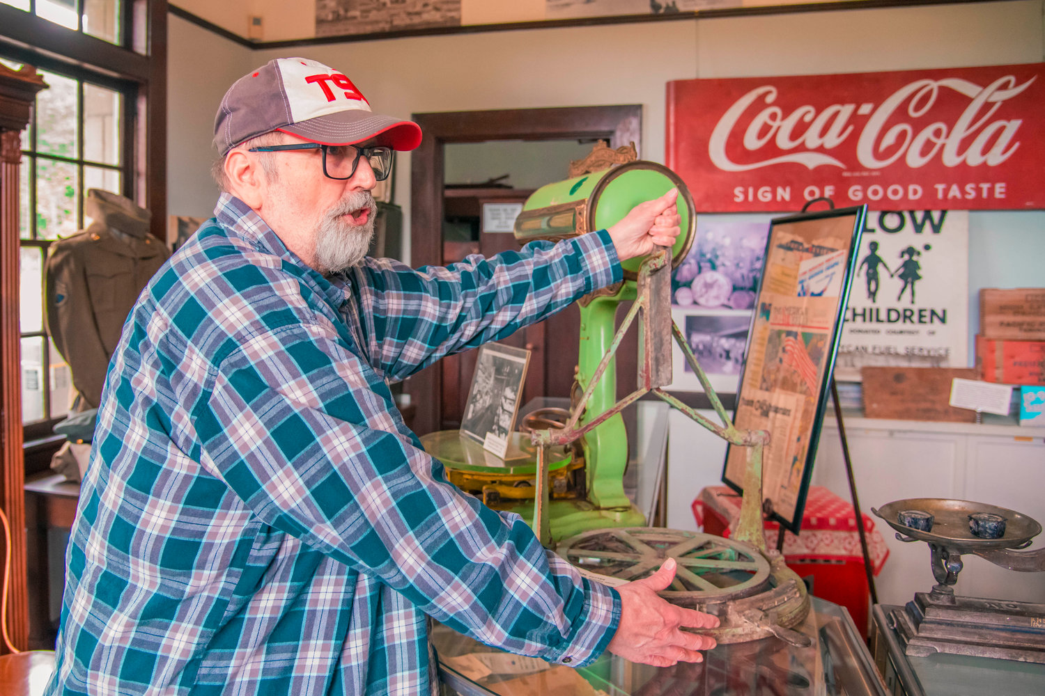 Tenino City Historian Richard Edwards talks about a vintage cheese slicer inside the Tenino Depot Museum on Tuesday.