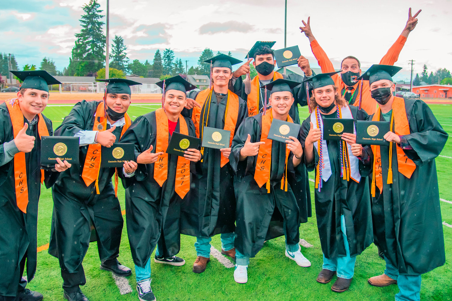 Centralia High School’s Assistant Principal Mike Stratton poses for a photo with graduates after they received their diplomas Friday night at Tiger Stadium.