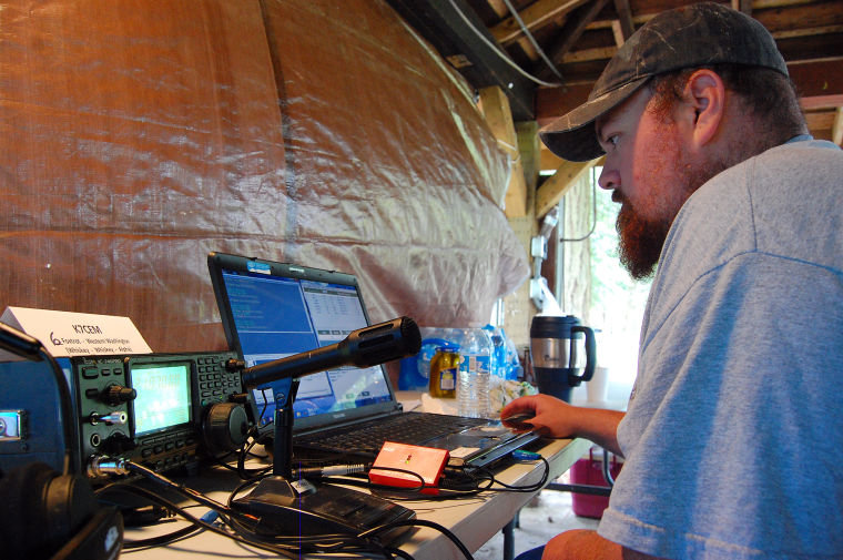 2014 FILE PHOTO — Jeff Mayfield of Centralia looks at a laptop monitor to see who his ham radio is communicating with on a high frequency at the Centralia ARES tent at the American Radio Relay League 2014 Field Day in June 2014.