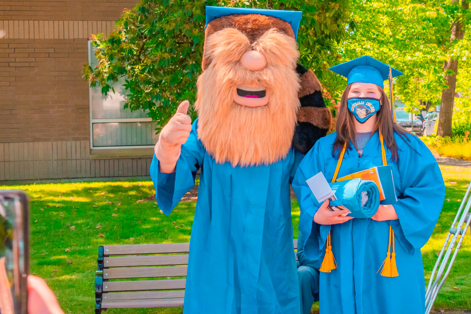 Hannah Ireton poses for a photo with the Trailblazers mascot after receiving her diploma during the Centralia College graduation ceremony on Friday.