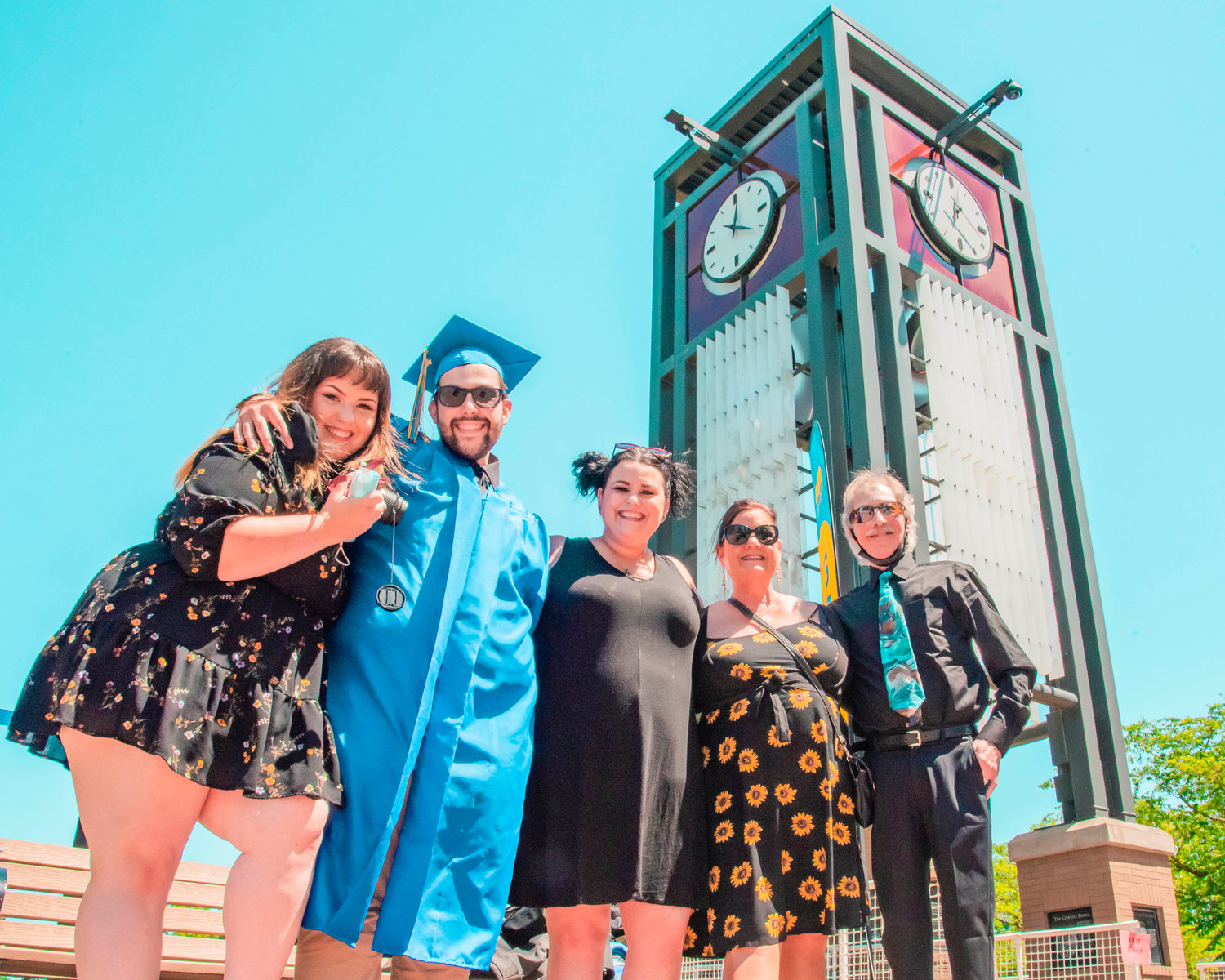 Taylour Beigh poses for a photo with his girlfriend Kelsie, sister Brittany, and parents Linda and Stan in front of the Centralia College clock tower after receiving his diploma on Friday. . Centralia College hosted a modified in-person commencement ceremony from noon to 5:30 p.m. Friday. Each graduate was allotted a specific number of tickets. There was no seating at the event, and graduates left after getting diplomas.